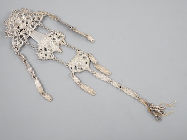 An Edwardian silver chatelaine, pierced and decorated with masks and scrolls, Nathan & Hayes, Chester, 1903, 21.6cm, 78 grams.